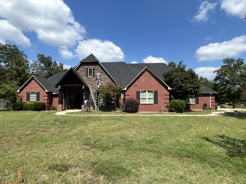 Brick home roofing project — crew on site